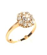 An early 20th century rose gold and diamond cluster ring. Centred with an old-cut diamond approx.