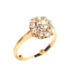 An early 20th century rose gold and diamond cluster ring. Centred with an old-cut diamond approx.