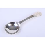An antique white metal spoon.