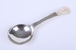 An antique white metal spoon.