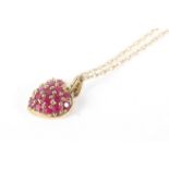 A 9ct gold and ruby encrusted heart-shaped pendant necklace and a pair of earrings.