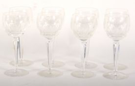 Eight Waterford cut wine glasses. With panel cut bowls, on faceted stems, 18.