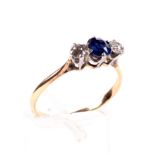 An early 20th century gold, sapphire and diamond three stone ring.