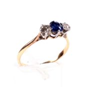 An early 20th century gold, sapphire and diamond three stone ring.