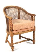 An Edwardian beech bergere and barley twist armchair.