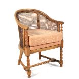 An Edwardian beech bergere and barley twist armchair.