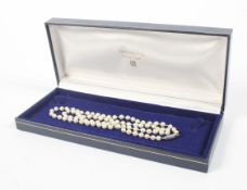 A cultured pearl single row necklace. The uniform beads approx. 4.8-5.