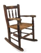 A late 19th century rush seated child's rocking chair.