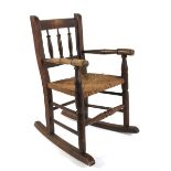 A late 19th century rush seated child's rocking chair.