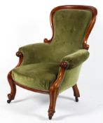 A Victorian mahogany framed upholstered armchair.