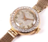 A ladies 18ct gold cased cocktail watch with diamond set bezel.