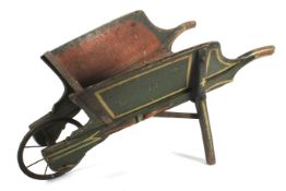 A small antique painted pine wheelbarrow.