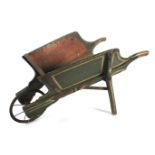 A small antique painted pine wheelbarrow.