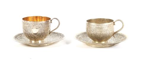 Two Middle Eastern white metal teacups and saucers.