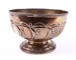 An embossed silver footed bowl.