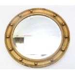 A Regency style giltwood circular mirror. With studded and reeded frame, 45 cm diam.