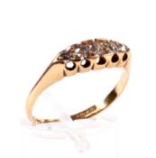 A late Victorian 18ct gold and diamond five stone ring. The graduated old-cut stones approx.