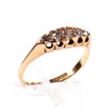 A late Victorian 18ct gold and diamond five stone ring. The graduated old-cut stones approx.