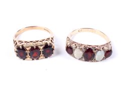 Two 9ct gold and garnet cast half-hoop rings.