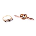 A 9ct gold, tiny sapphire and diamond five stone ring and a gold lovers knot brooch.
