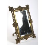 A Victorian brass mirror frame.