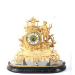 A 20th century gilt-metal mantel clock on an ebonised base and under a glass dome.