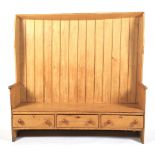 A large 19th century high-backed pine settle.