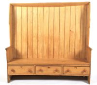 A large 19th century high-backed pine settle.