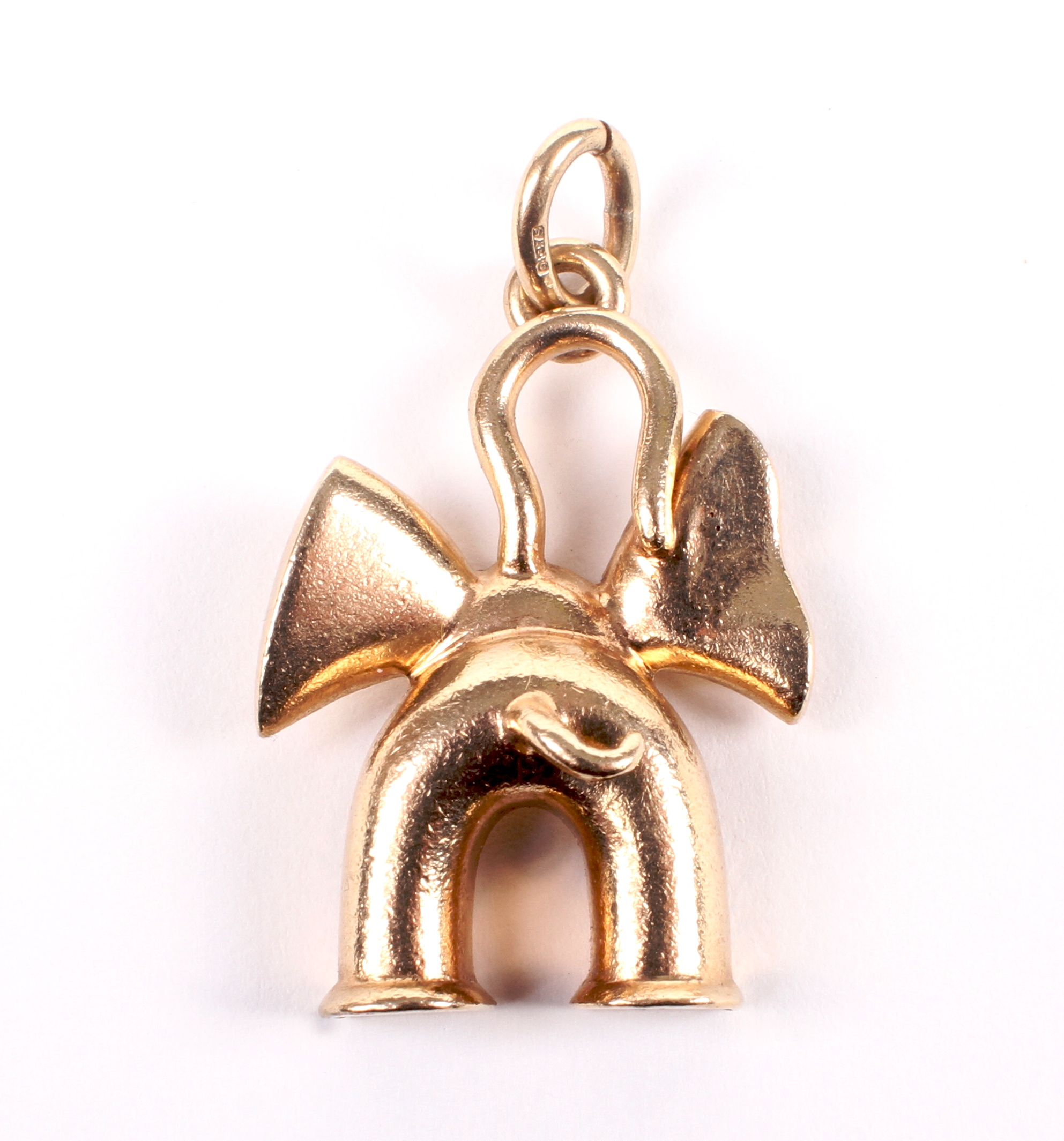 A 9ct gold pendant in the form of an elephant viewed from behind.