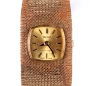 A 9ct gold ladies Tissot stylist wristwatch.