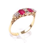 An early 20th century gold, ruby and diamond carved half-hoop ring in Victorian style.