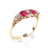 An early 20th century gold, ruby and diamond carved half-hoop ring in Victorian style.