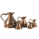 Five 19th century copper measuring jugs.