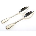 Two Victorian silver serving spoons.