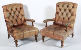 A pair of Victorian button back leatherette upholstered armchairs.
