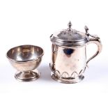 A silver mustard pot and a footed condiment bowl.