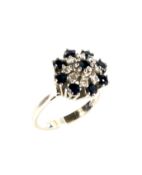 An 18ct white gold, sapphire and diamond tiered flower-head cluster ring.