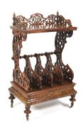 A mid Victorian inlaid walnut veneered etagere canterbury.