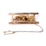 An early 20th century gold nugget and sluice box brooch.