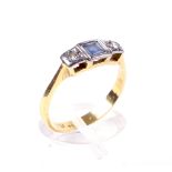 An early 20th century gold, blue stone and diamond three stone ring.
