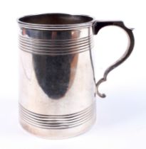 A silver tapering cylindrical tankard.