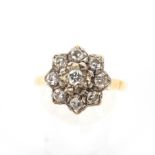 A mid-20th century gold and diamond cluster ring. The nine round brilliants approx. 0.