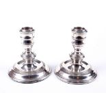 A pair of silver squat candlesticks.