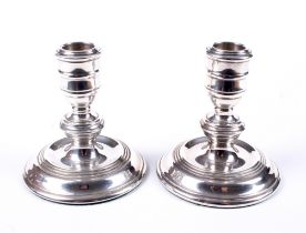 A pair of silver squat candlesticks.