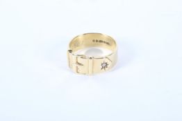 A gents 9ct gold buckle ring. Set with a single white stone, ring size U, 7.