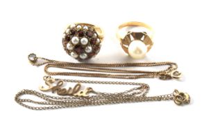 A 9ct gold garnet and seed pearl set dress rings, a gold pearl set dress ring,