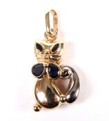 A vintage bi-colour metal and sapphire pendant in the form of a seated Siamese cat.