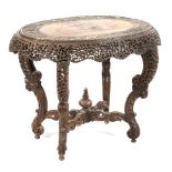 An Anglo-Indian heavily carved hardwood oval table, late 19th century.