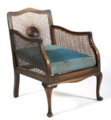 An early 20th century caned bergere armchair.