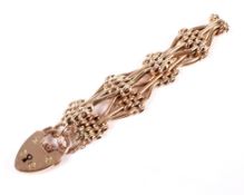 An early 20th century rose gold fancy three-bar and block bracelet.